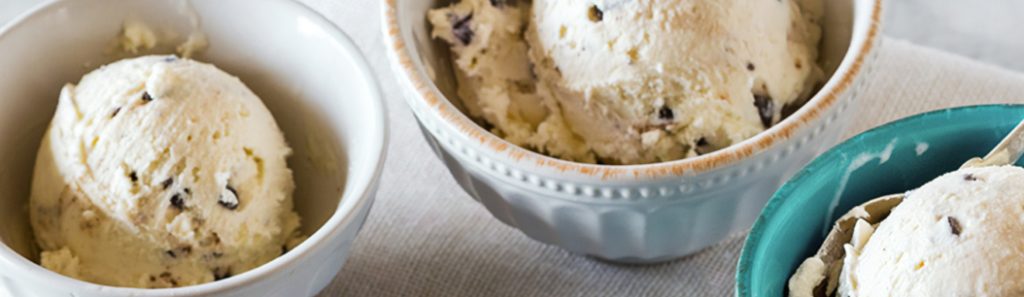A bowl of ice cream with various sweeteners and flavors on top